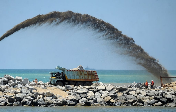 dum truck with flying sand